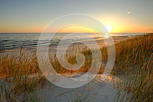 Dunes on the coast of the Baltic Sea, sunrise on the beach on a summer day.